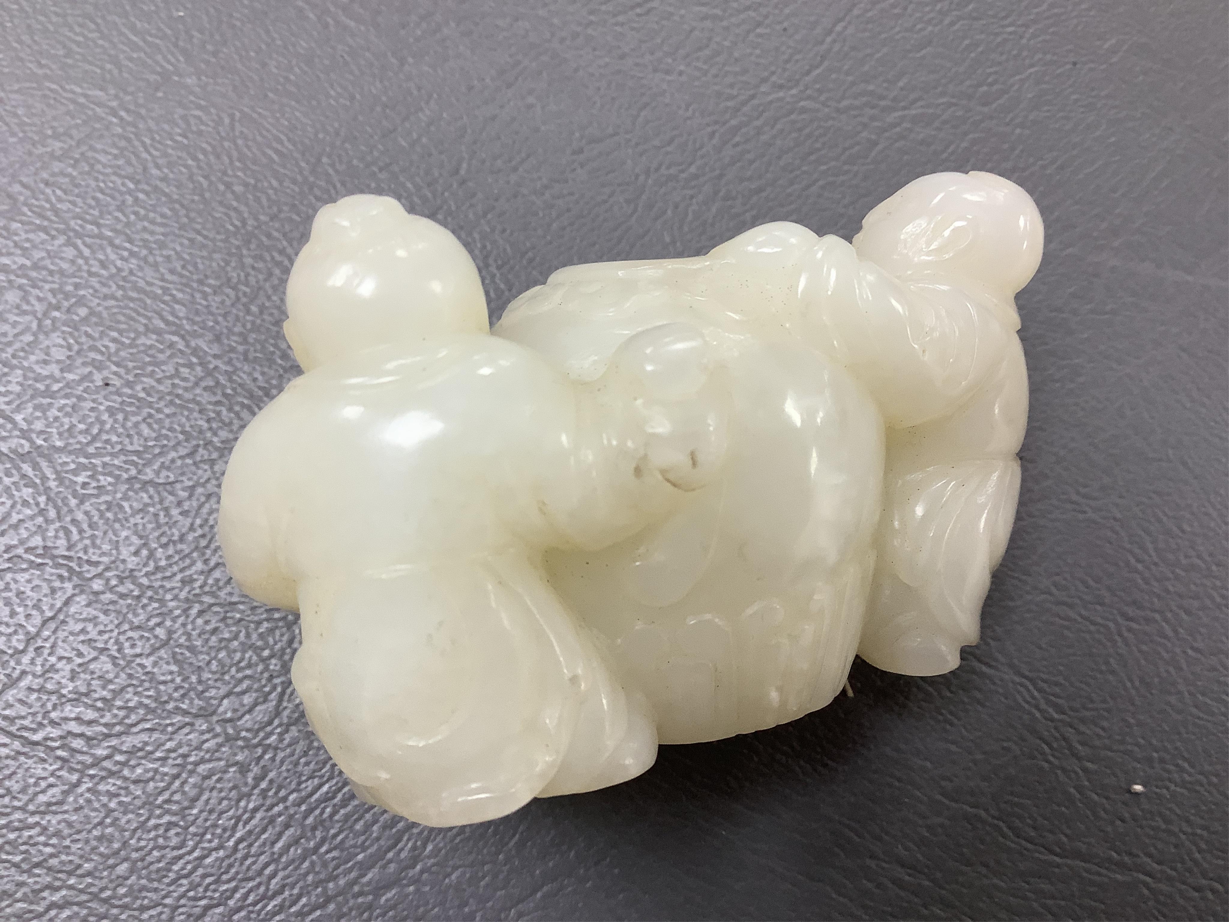A Chinese white jade 'boys with jar' carving and three shoushan stone figures; luohan, girl with squirrel and mermaid (4), tallest 11cm